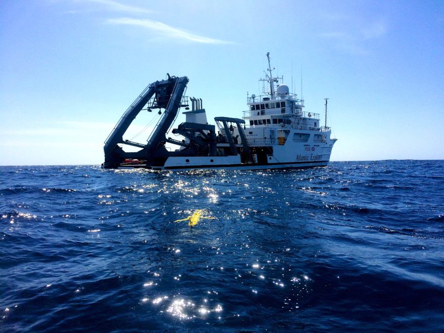 Research Vessel out at sea with an autonomous glider in the water (Photo Credit: Jeremiah Brower)