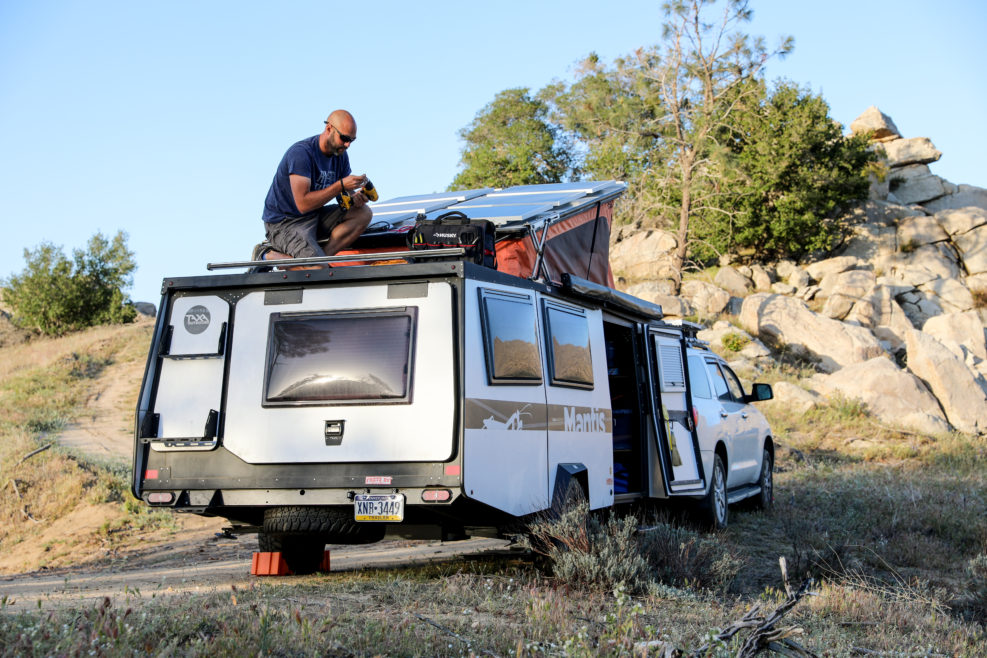 Nick installing solar panels on his Taxa Mantis trailer